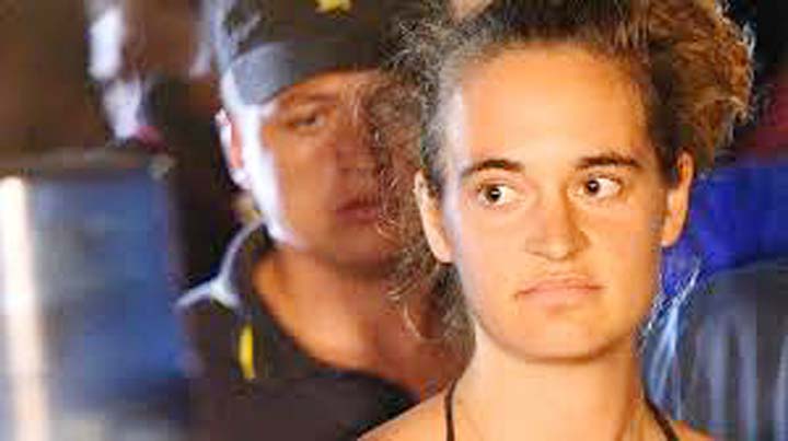 Carola Rackete, 31-year-old Sea-Watch 3 captain, is escorted off the ship by police and taken away for questioning, in Lampedusa, Italy.