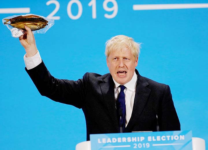 Boris Johnson holds a plastic wrapped kipper fish during a hustings event in London, Britain.