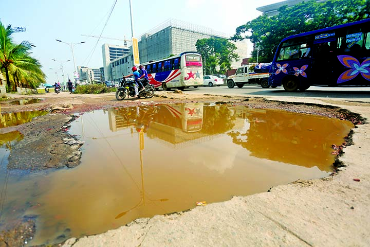 A vital portion of highway in Uttara near Armed Police Office is in dilapidated condition where big potholes and cracks following incessant rains for the last few days and works relating to metro-rail project, other development works. This photo was taken
