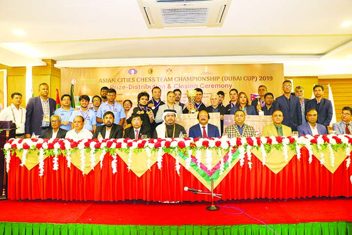 The winners of the Asian Cities Chess Team Championship (Dubai Cup) 2019 with the guests and officials of Bangladesh Chess Federation pose for a photo session in a city hotel on Wednesday.