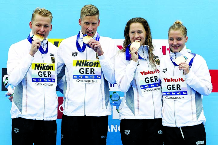 Members of the gold medal-winning team from Germany stand with their medals after the 5km mixed relay open water swim at the World Swimming Championships in Yeosu, South Korea on Thursday.
