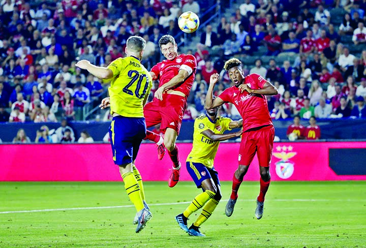 Bayern Munich forward Robert Lewandowski (second from left ) scores on a header against Arsenal during the second half of an International Champions Cup soccer match in Carson, Calif on Wednesday.