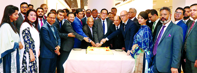 A Rouf Chowdhury, Chairman of the Bank Asia, celebrating an achievement of collection of Tk 1,000 crore deposits by cutting a cake at the bank's corporate office at Karwan Bazar in the city recently. Rumee A Hossain, Chairman of Board Executive Committee