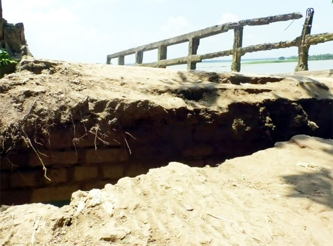 Communication in between 30 villages under Singra Upazila in Natore was snapped as a bridge was severely damaged due to river erosion and onrush of floodwater. The snap was taken on Friday.