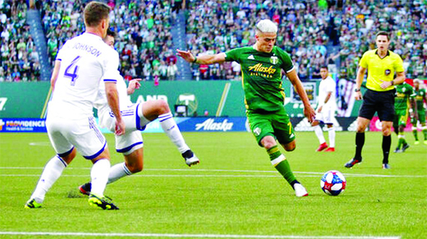 Portland Timbers' Brian Fernandez attempts a shot on goal as Orlando City players, including Will Johnson (4) defend during an MLS soccer match in Portland, Ore on Thursday.