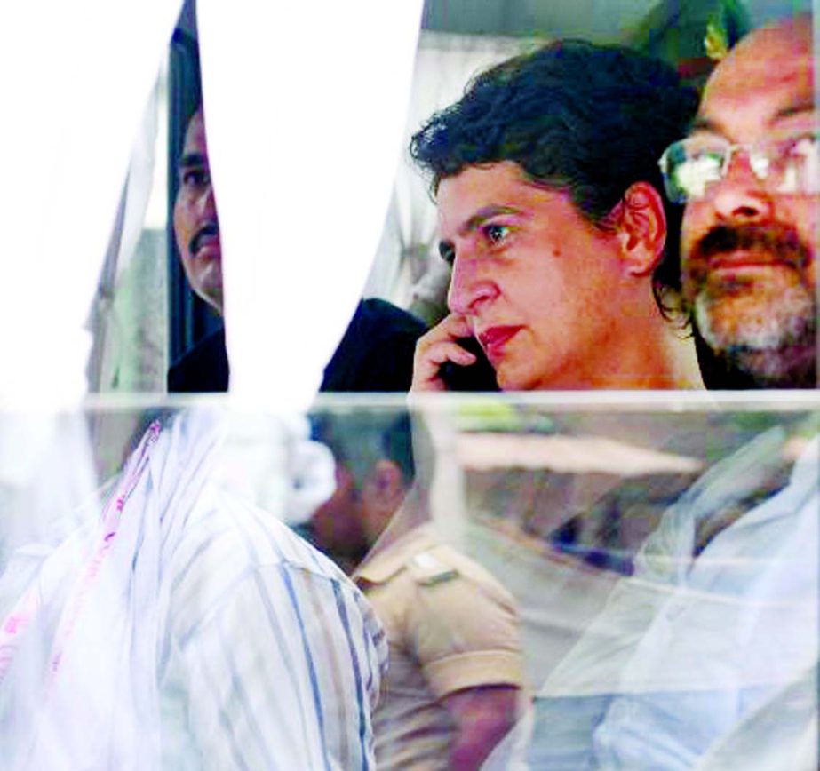 Indian politician Priyanka Gandhi Vadra looks on as she is taken in an official vehicle after being arrested at Narayanpur district, Mirzapur.