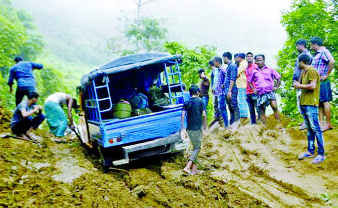 Road link between Ruma and Bandarban remained suspended for 12 days due to landslides and torrential rains as a vehicle got stuck seen in the picture. This photo was taken from Bandarban on Friday.