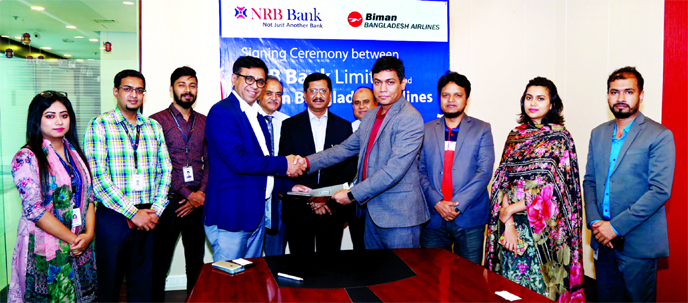 Mir Shafiqul Islam, Head of Cards NRB Bank Ltd and Mohammed Salahuddin, General Manager Marketing of Biman Bangladesh Airlines, exchanging an agreement signing document at the bank's corporate office recently. Under the deal, NRB Bank debit and credit ca