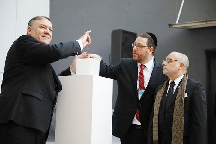 US Secretary of State Mike Pompeo lights a candle next to Argentine Foreign Minister Jorge Faurie and the President of the Association Mutual Israelita Argentina (AMIA) Ariel Eichbaum to pay homage to the victims of a bombing at the center which left 85 p