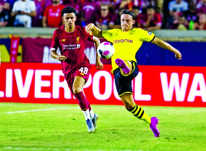 Borussia Dortmund's Nico Schulz keeps the ball away from Liverpool's Adam Lewis during an exhibition soccer match at Notre Dame Stadium in South Bend, Ind on Friday.