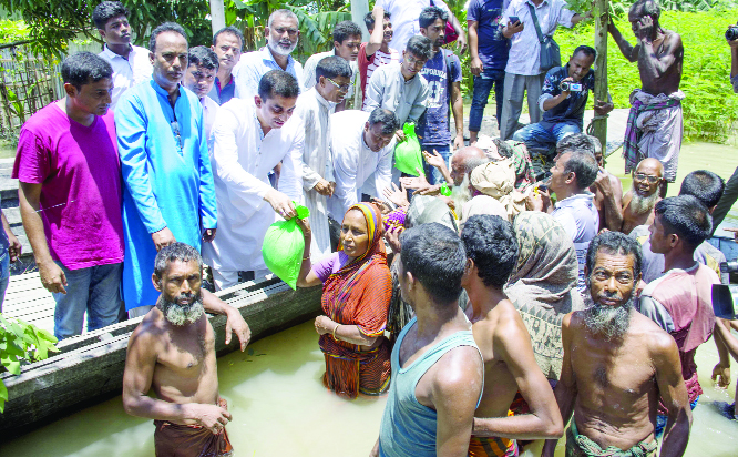 GAIBANDHA: Mahmud Hasan Rimon, former President of Chhatra League distributing relief goods among the flood- hit people at Jhumarbari Union on Saturday.