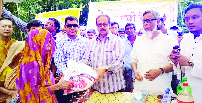 SYLHET: Mahmud -us -Samad Chowdhury MP and Mustaquar Rahman Mofu, Chairman, Balaganj Upazila distributing relief materials among flood affected people at Radhakona village on Saturday.