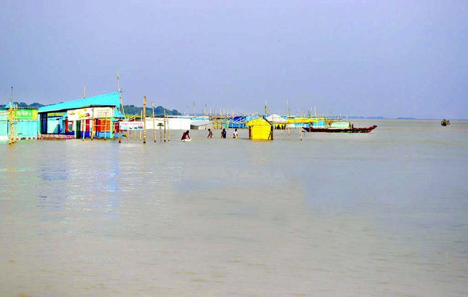 Several houses being submerged as flood waters alarmingly rising on the outskirts of the capital following the receding of water in northern region of the country. This photo was taken from Dohar area on Sunday.