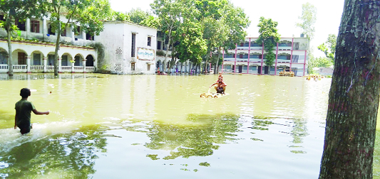 SARISHABARI (Jamalpur) : The Academic Building of Aramnagar Kamil Madrasha at Sarishabari has been inundated. This picture was taken on Sunday.