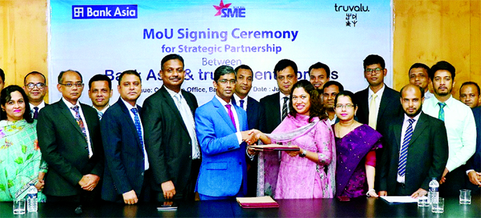 Md Arfan Ali, President and Managing Director of Bank Asia Ltd and Sharawwat Islam, Managing Director of Truvalu enterprises Ltd, exchanging an agreement signing document at the bank's corporate office in the city recently.