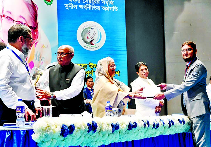 Prime Minister Sheikh Hasina presenting National Fisheries Award to Mostofa Al Rajib, Upazila Fisheries Officer, Betagi , Barguna for the latter's contribution in Fisheries Sector at a ceremony held recently in the auditorium of Krishibid Institution,