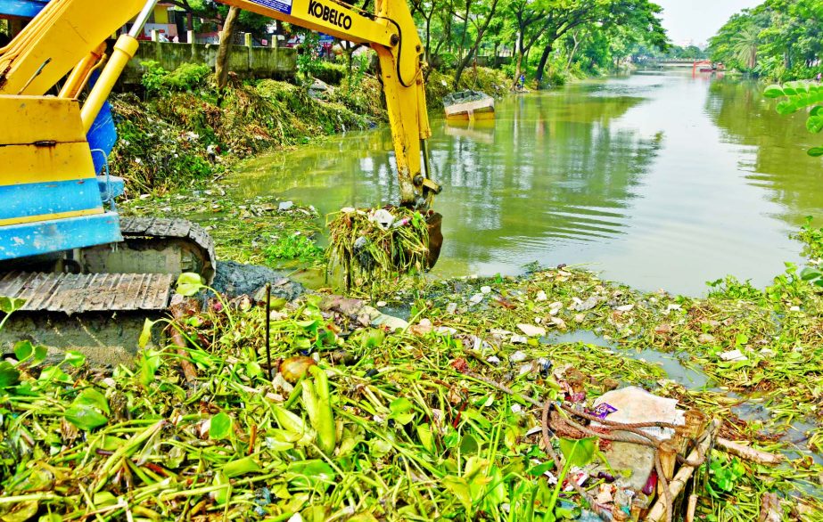 Dhaka South City Corporation authority removing waste to keep free from dengue menace. This photo was taken from city's Matuail canal on Tuesday.