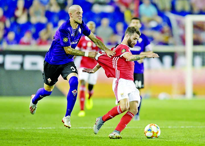Fiorentina defender Cristiano Biraghi (3) grabs the jersey of Benfica midfielder Rafa during the second half of an International Champions Cup soccer match in Harrison, N.J on Wednesday. Benfica won 2-1.