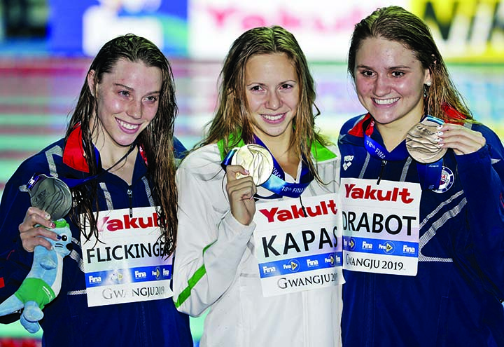 Gold medalist Hungary's Boglarka Kapas (centre) stands with silver medalist United States' Hali Flickinger (left) and her compatriot and bronze medalist Katie Drabot following the women's 200m butterfly final at the World Swimming Championships in Gwan