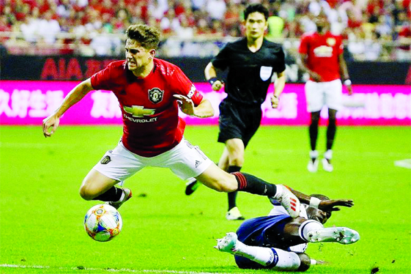 Manchester United's Daniel James goes flying after a tackle by Tottenham midfielder Moussa Sissoko in a heated International Champions Cup match in Shanghai on Thursday. United won 2-1.