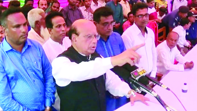 SAGHATA (GAIBANDHA): Mohammad Nasim MP speaking at a meeting during a relief distribution programme at Kochuya High School in Saghata Upazila as Chief Guest on Friday.