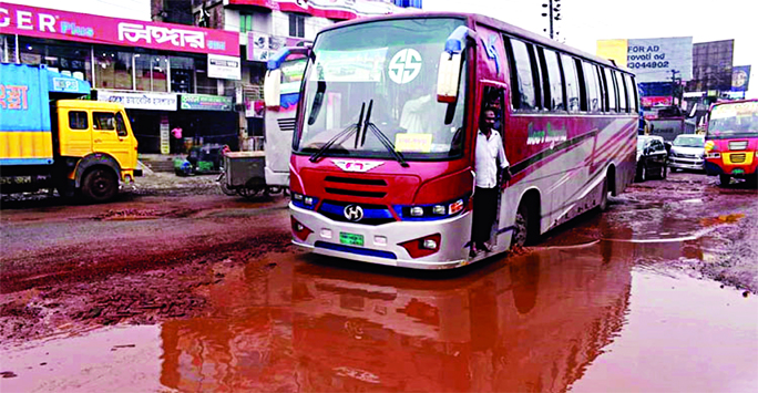 Hundreds of vehicles had to ply on Dhaka-Tangail Highway with huge risk of accident as the condition of the pothole-ridden road further worsens due to incessant rain and ongoing development work causing immense sufferings to the passengers. This photo was