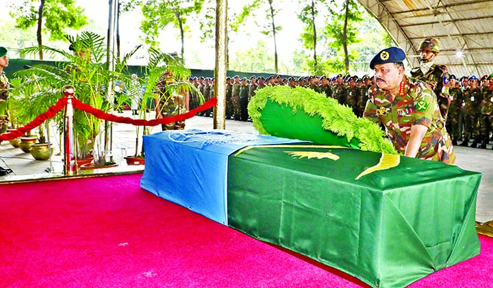 Chief of Bangladesh Army Staff General Aziz Ahmed placing wreaths at the coffin of a Bangladeshi peacekeeper who was electrocuted in Middle South Africa Republic after Namaj-e-Janaza yesterday .