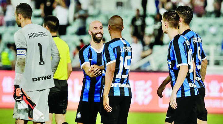 Inter Milan's players celebrate winning the match against Paris St. Germain in a penalty shootout after their International Super Cup football match in Macau on Saturday.