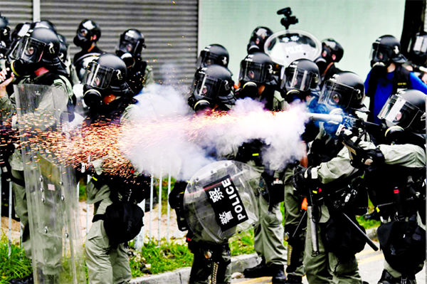 Riot police used tear gas in Yuen Long on Saturday after tense standoffs with protesters, some of whom were throwing projectiles.