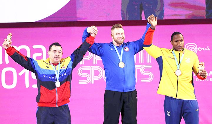 Jesus Gonzalez of Venezuela (left) Wesley Kitts of United States (center) and Jorge Arroyo of Ecuador pose with their medals during men's 96 kg weightlifting at the Pan American Games in Lima, Peru on Monday.