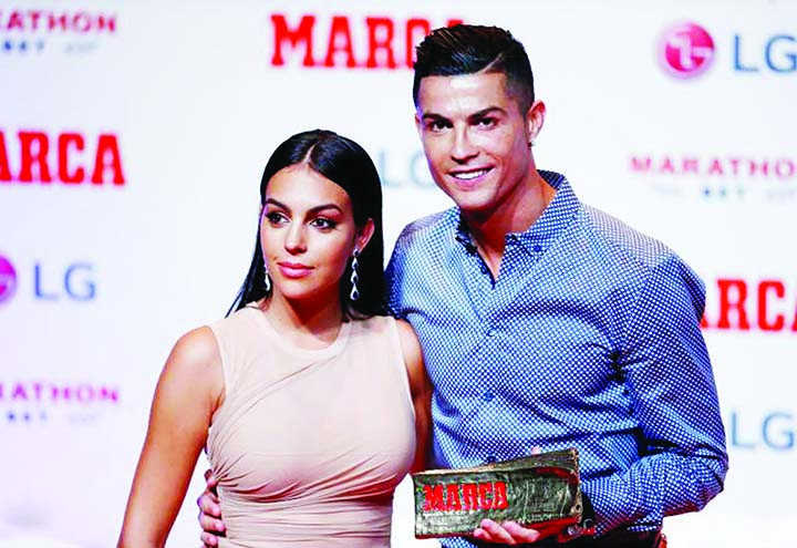 Portugal and Juventus forward Cristiano Ronaldo poses with his partner and Spanish model Georgina Rodriguez (left) after receiving the MARCA Leyenda (MARCA Legend) award in Madrid, Spain on Monday.