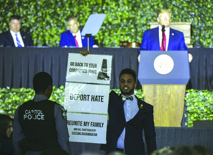 Ibraheem Samirah, a Democratic Virginia assemblyman, protests during US President Donald Trump's speech.