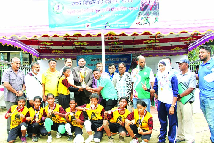 Members of Salondor High School of Thakurgaon, the champions in the First Security Islami Bank Limited Under-17 Girls' School Rugby Competition with the guests and officials of Bangladesh Rugby Union pose for a photo session at the Paltan Maidan on Wedne