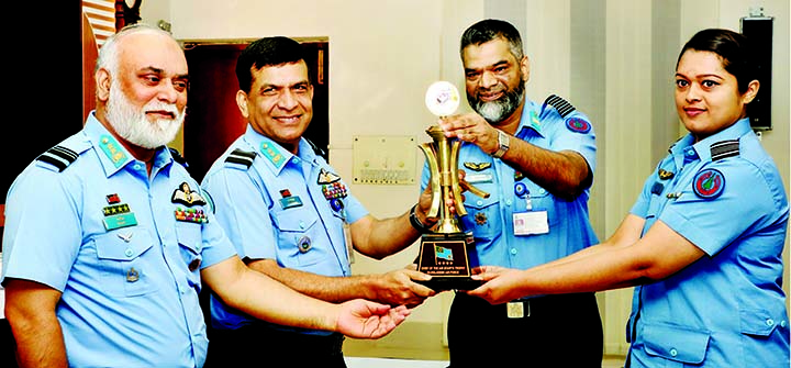 Assistant Chief of Air Staff (Operations) Air Vice Marshal M Abul Bashar giving away the 'Chief of Air Staff's Certificate and Trophy' to Squadron Leader Farzana Sharmin of Bangladesh Air Force for her best performance on 'No. 111 Junior Command and S