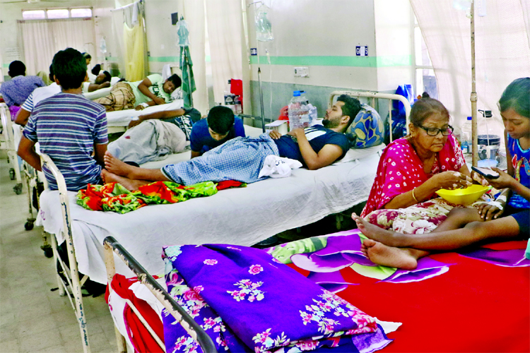 A mother feeding meal to her 12-year old hospitalised daughter who has been suffering from dengue fever for the last one week. The photo was taken from the city's Holy Family Hospital on Friday.