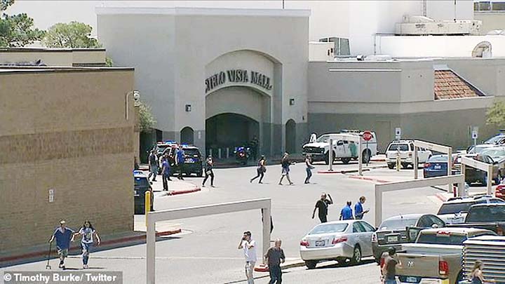 Panicked shoppers flee the Cielo Vista Mall in El Paso on Saturday after a gunman opened fire inside a nearby Walmart