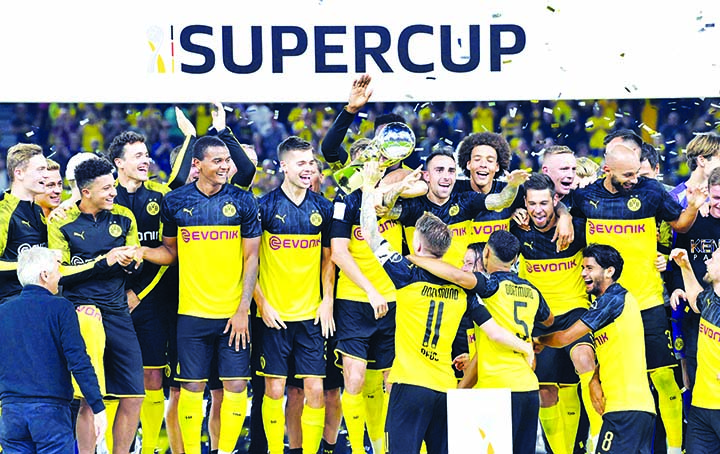 Players of Borussia Dortmund celebrating after beating Bayern Munich 2-0 to win the German Super Cup title at Dortmund in Germany on Saturday.