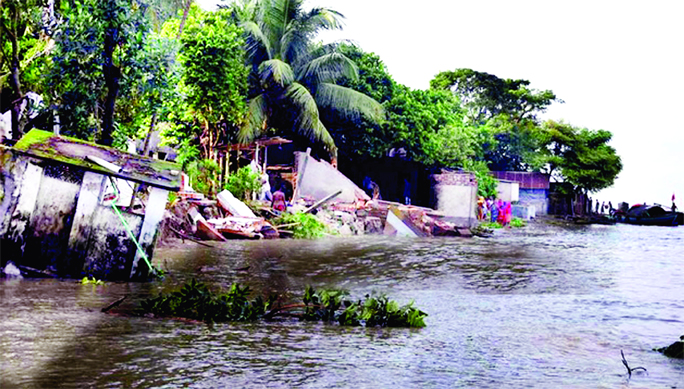 Hundreds of houses being threatened as about 200-meter bloc of Chandpur Town Protection Embankment eroded in Meghna due to start receding of flood water. This photo was taken from Puran Bazar area of Harisabha on Sunday.
