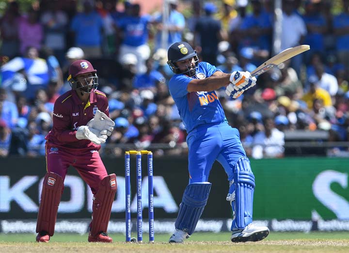 Rohit Sharma of India hits a shot as Nicholas Pooran (left) of West Indies looks on during their 2nd T20 match at Central Broward Regional Park Stadium in Lauderhill, Florida on Sunday.