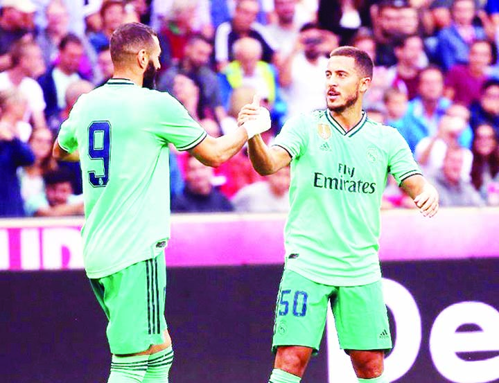 Eden Hazard (right) celebrates with teammate Karim Benzema (left) after scoring for Real Madrid in a 1-0 pre-season friendly win over Red Bull Salzburg on Wednesday. Eden H