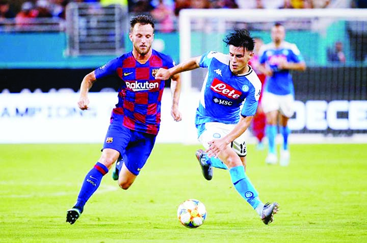 Napoli's Lorenzo Insigne (right) battles for the ball with Barcelona's Ivan Rachitic (left) during the matchup of European giants at Miami on Wednesday.