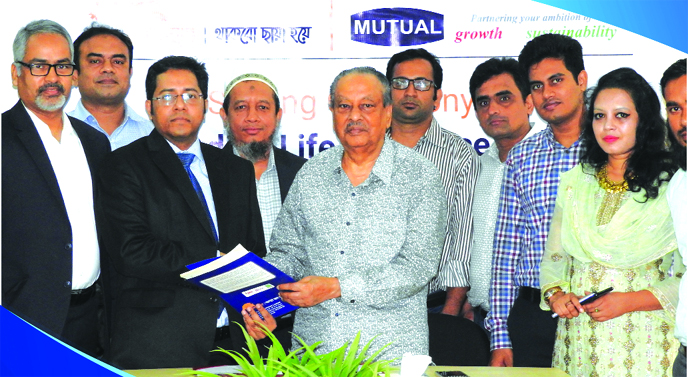 Mohammad Shazzadul Karim, DMD of Guardian Life Insurance Company Limited (GLICL) and Azim Uddin Ahmed, Chairman of Mutual Group (MG), exchanging an agreement signing document at GLICL head office in the city recently. Senior officials from both sides were