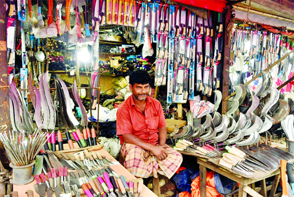 A man waiting to sell knives, kitchen knives and other things to slaughter sacrificial animals during holy Eid-ul-Azha. The snap was taken from the city's Karwan Bazar on Friday.