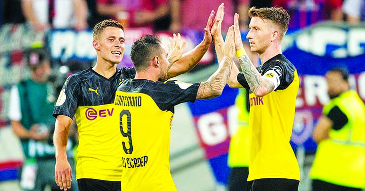 Marco Reus (right) celebrates after scoring the second goal for Dortmund against KFC Uerdingen in the first round of the German Cup on Friday.