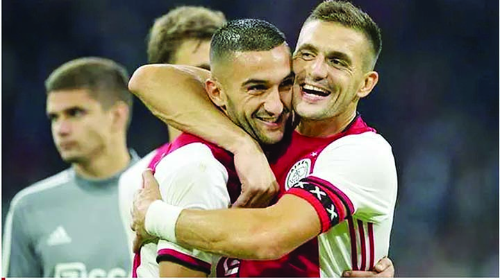 Ajax Amsterdam's Dusan Tadic (right) and teammate Hakim Ziyech celebrate after winning the UEFA Champions League third preliminary round football match against PAOK Saloniki in Amsterdam on Tuesday.