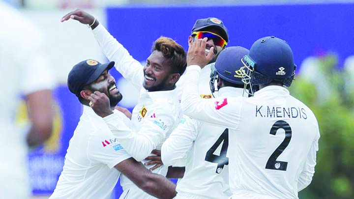 Sri Lanka's bowler Akila Dananjaya (second left) celebrates taking the wicket of New Zealand's Kane Williamson (not in picture) on a rain-hit day one of the first Test in Galle on Wednesday.