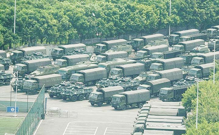 Armoured personnel carriers are seen outside a stadium in China's Shenzhen, bordering Hong Kong.