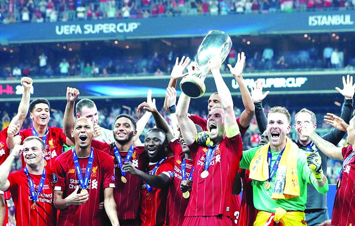 Liverpool team poses with the trophy after winning the UEFA Super Cup 2019 football match between FC Liverpool and FC Chelsea at Vodafone Park Stadium in Istanbul, Turkey on Wednesday.