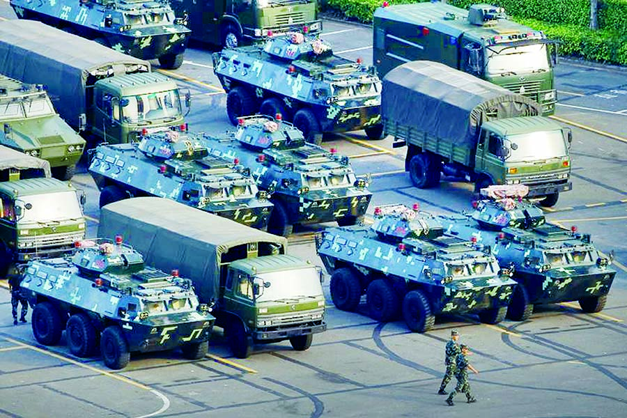 Military vehicles are parked on the grounds of the Shenzhen Bay Sports Center in Shenzhen, China on Thursday.