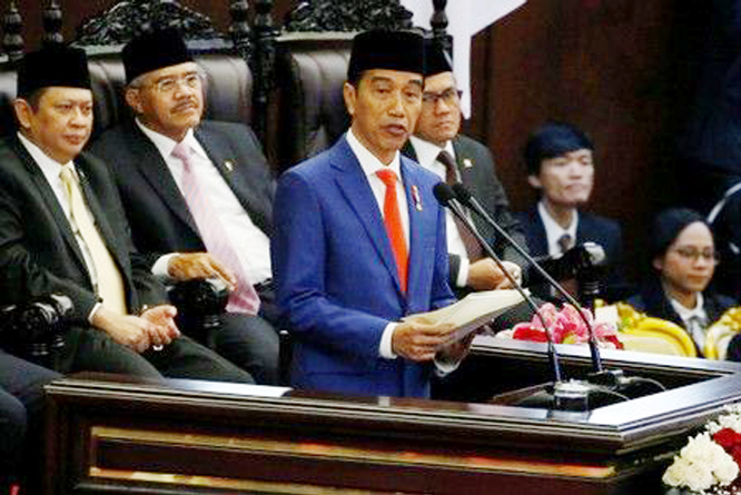 Indonesia President Joko Widodo gestures while delivering a speech in front of parliament members, ahead of Independence Day, at the parliament building in Jakarta.